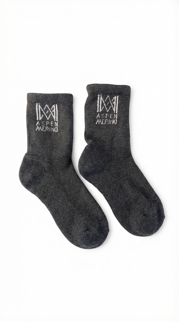 Pair of dark gray socks with Aspen Merino logo on a white background
