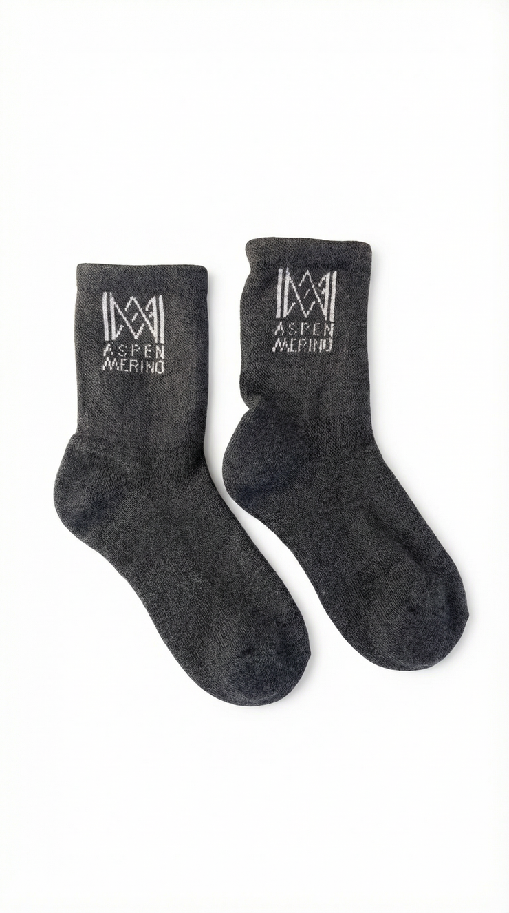Pair of dark gray socks with Aspen Merino logo on a white background