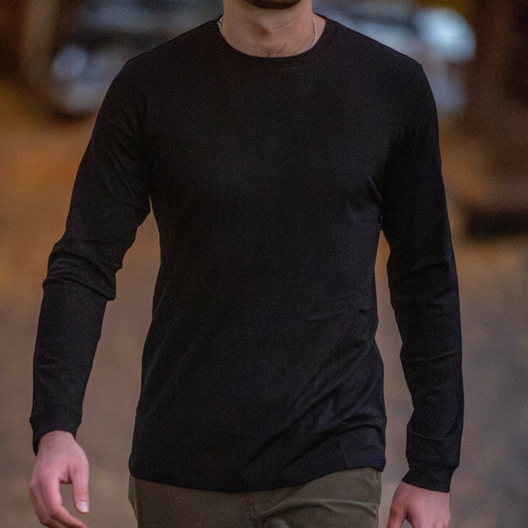 Close-up shot of an man wearing a black Merino Long Sleeve