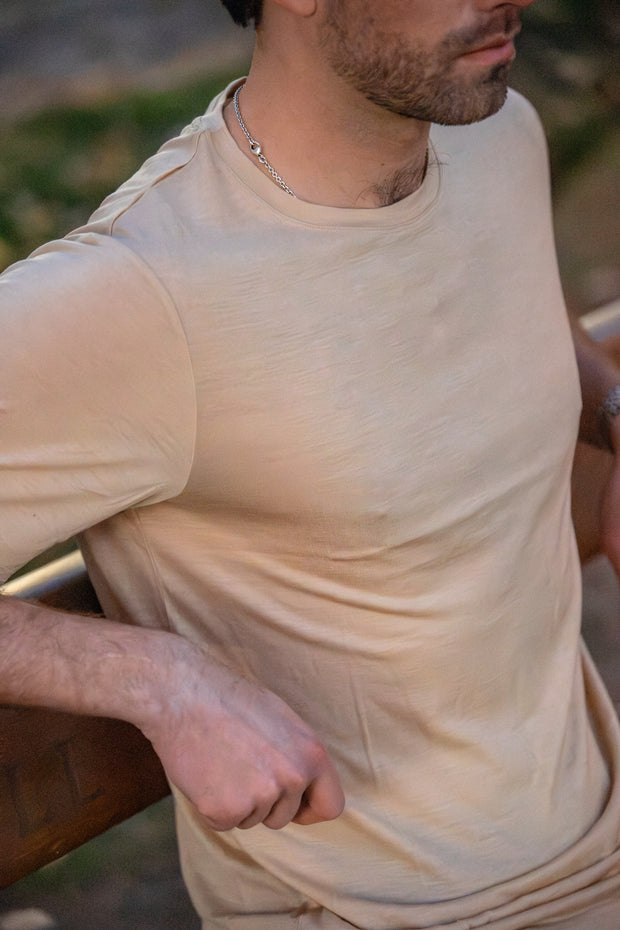 Man wearing a Silk Cashmere Merino T-Shirt with a blurred background