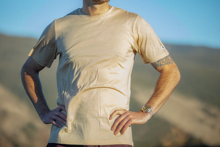 Man wearing a Silk Cashmere Merino T-Shirt with mountains in the background